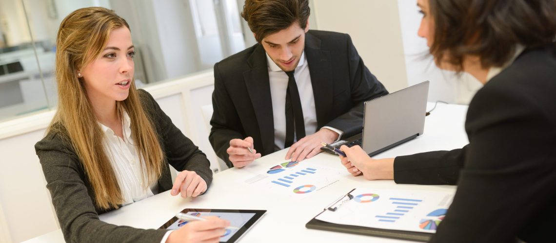 Image of business partners discussing documents and ideas at meeting